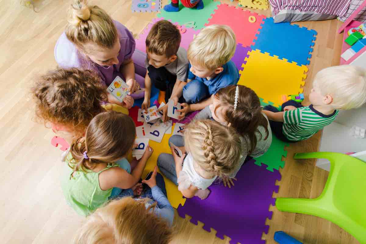 Bambini che giocano con la maestra a scuola